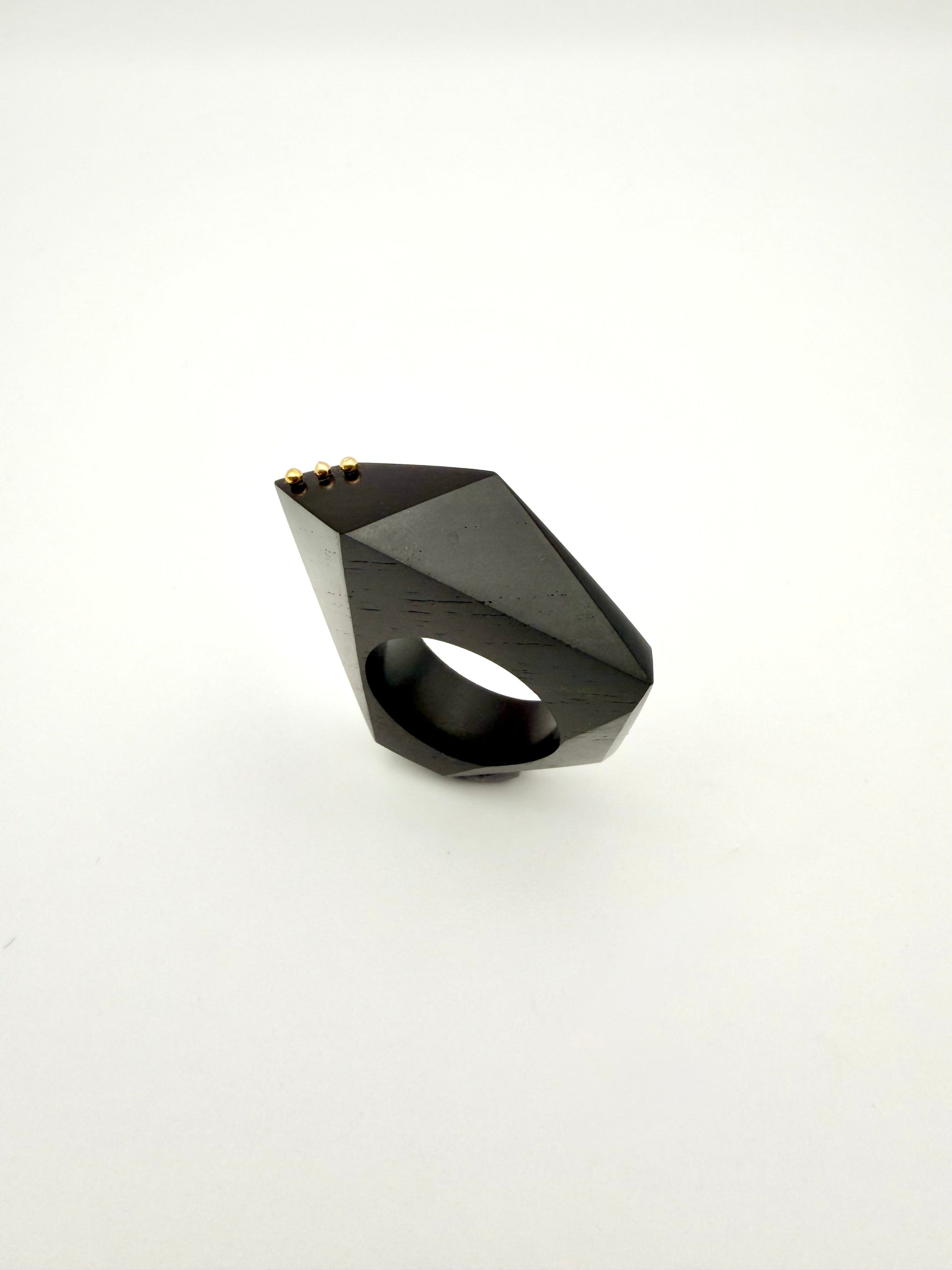 Black geometric ring on a white background