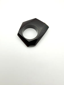 Black geometric ring on a white background