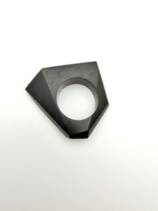 Black geometric Ring on its side on a white background