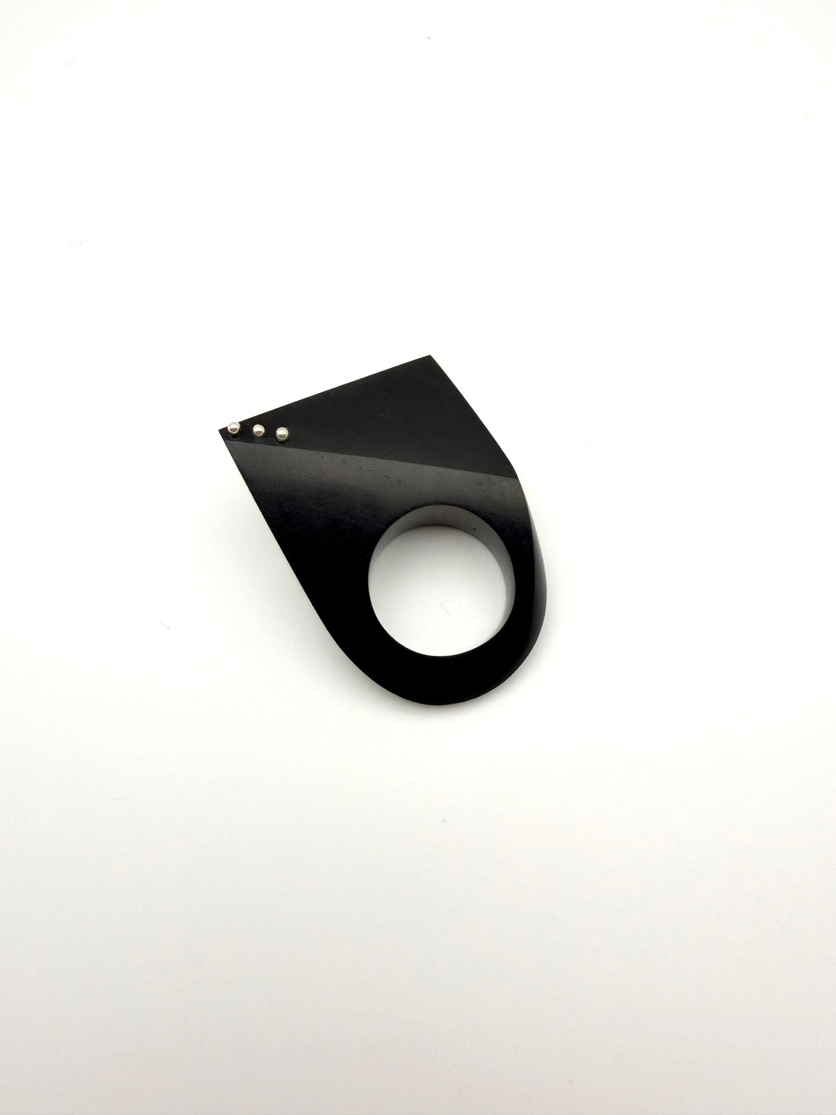 Black geometric wood ring with silver details on a white background