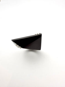 Black triangular ring shot from above on a white background