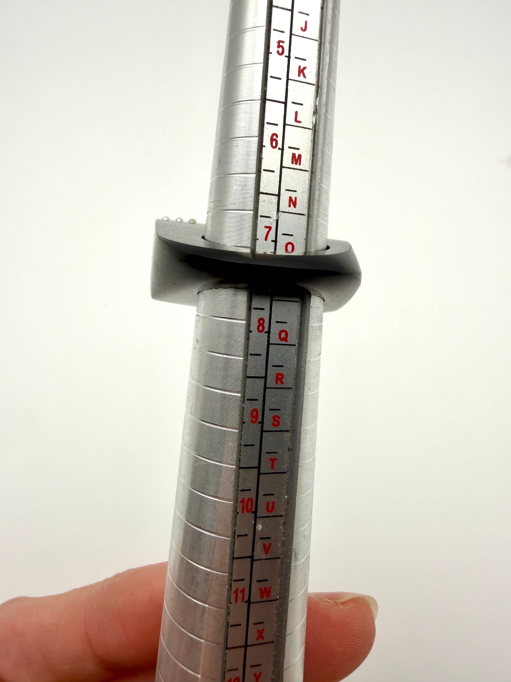 Wood ring on sizing tool for size reference. 