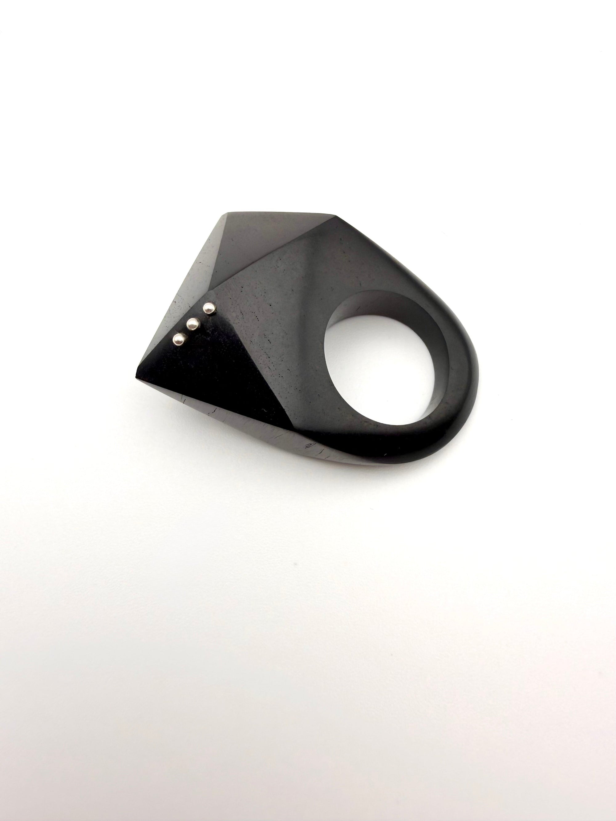 Black geometric ring on a white background