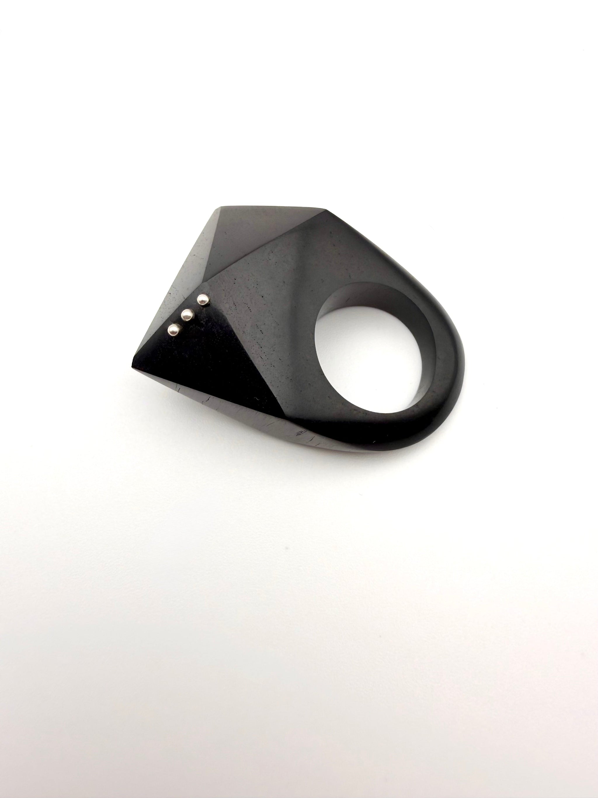 Black geometric ring on a white background
