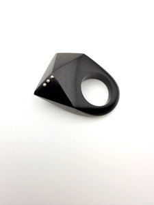Black geometric ring on a white background