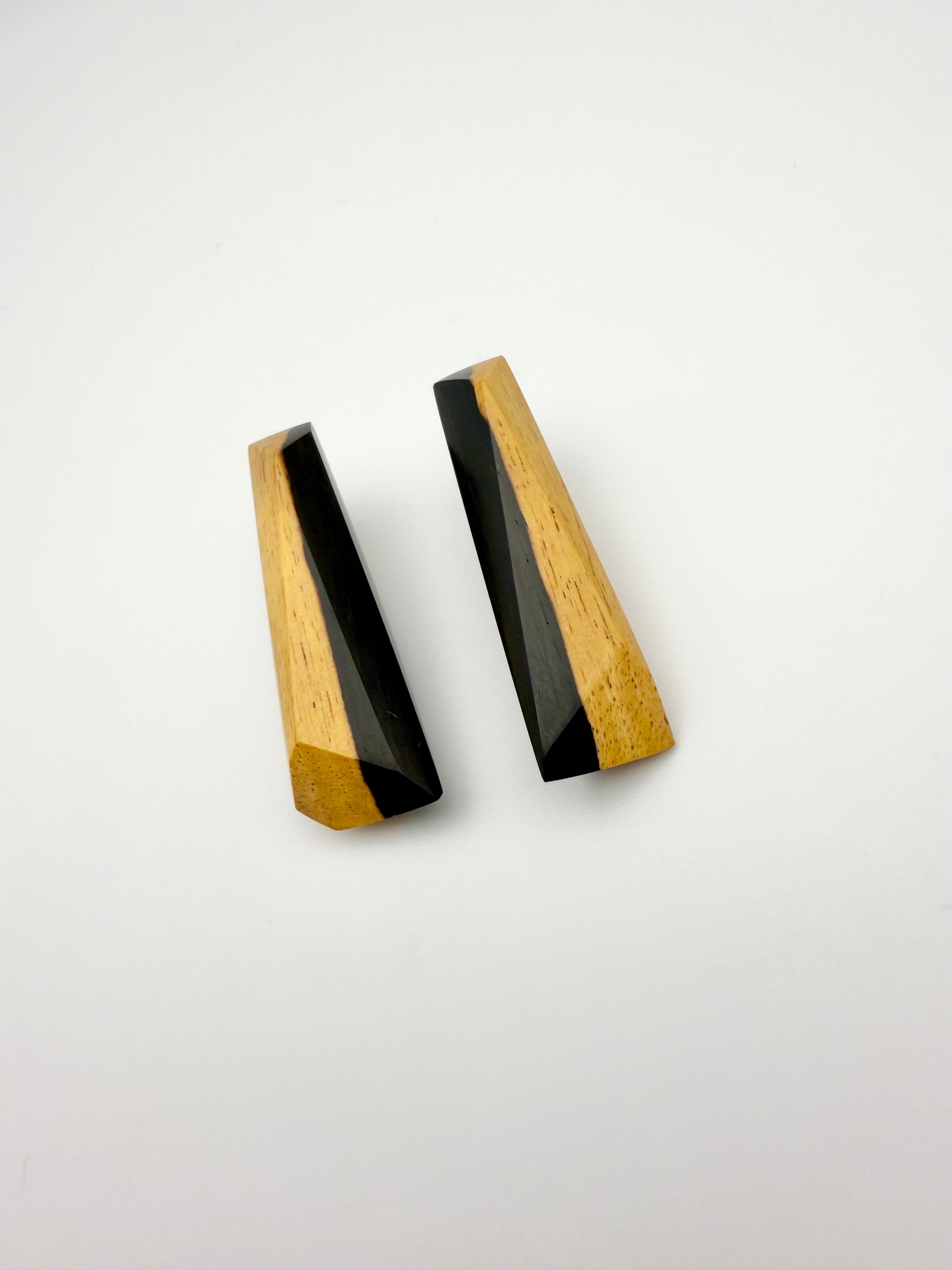 Pair of black and tan long wood stud earrings