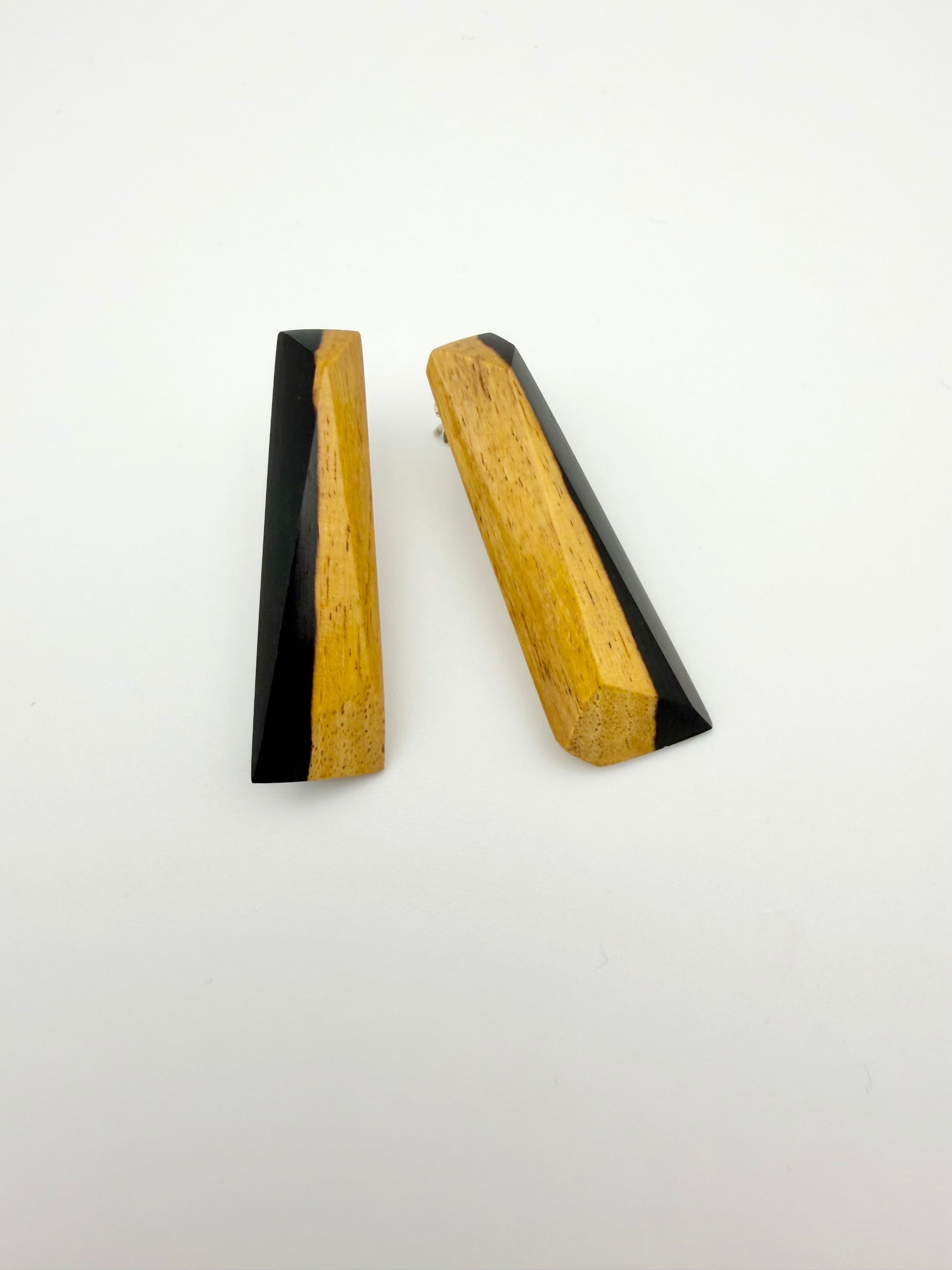 Pair of black and tan long wood stud earrings