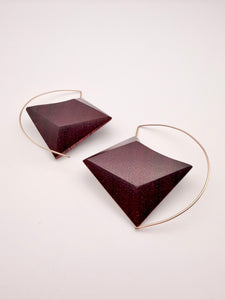 Back side of deep red wood geometric earrings with Gold Filled ear wires on a light background. 