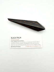 Wooden palm leaf on a white background with informational card sitting below it.