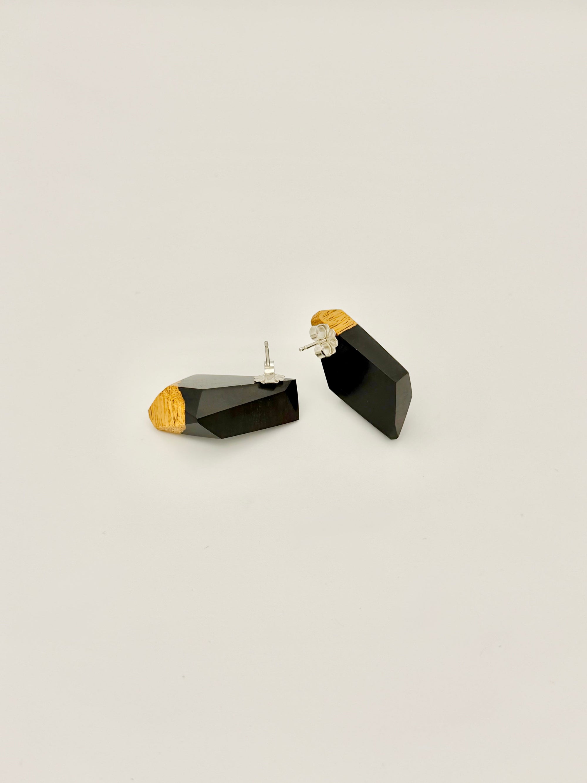 Black and gold wood earrings on a white background