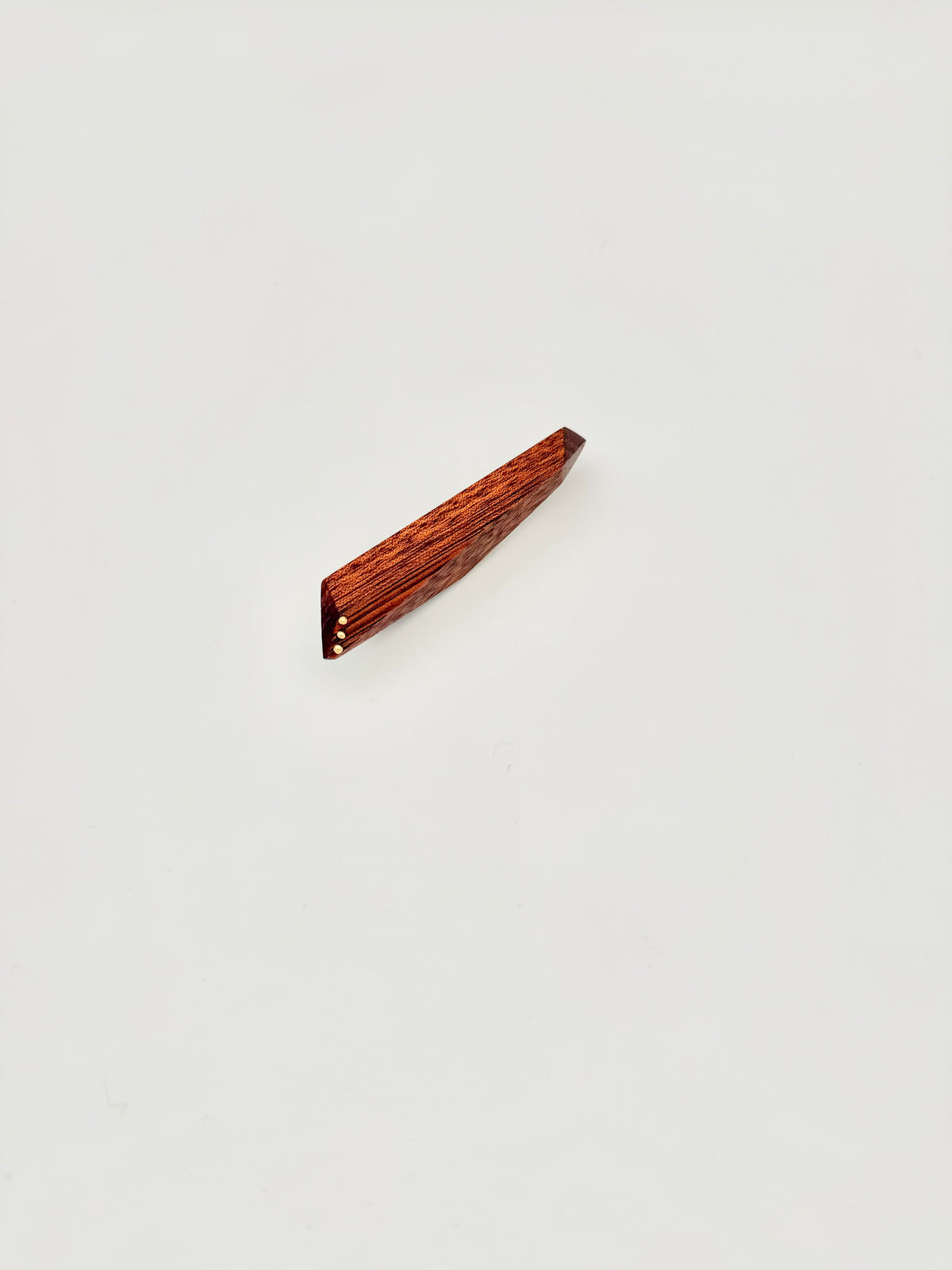 Red geometric wood brooch with 3 gold dot details on white background