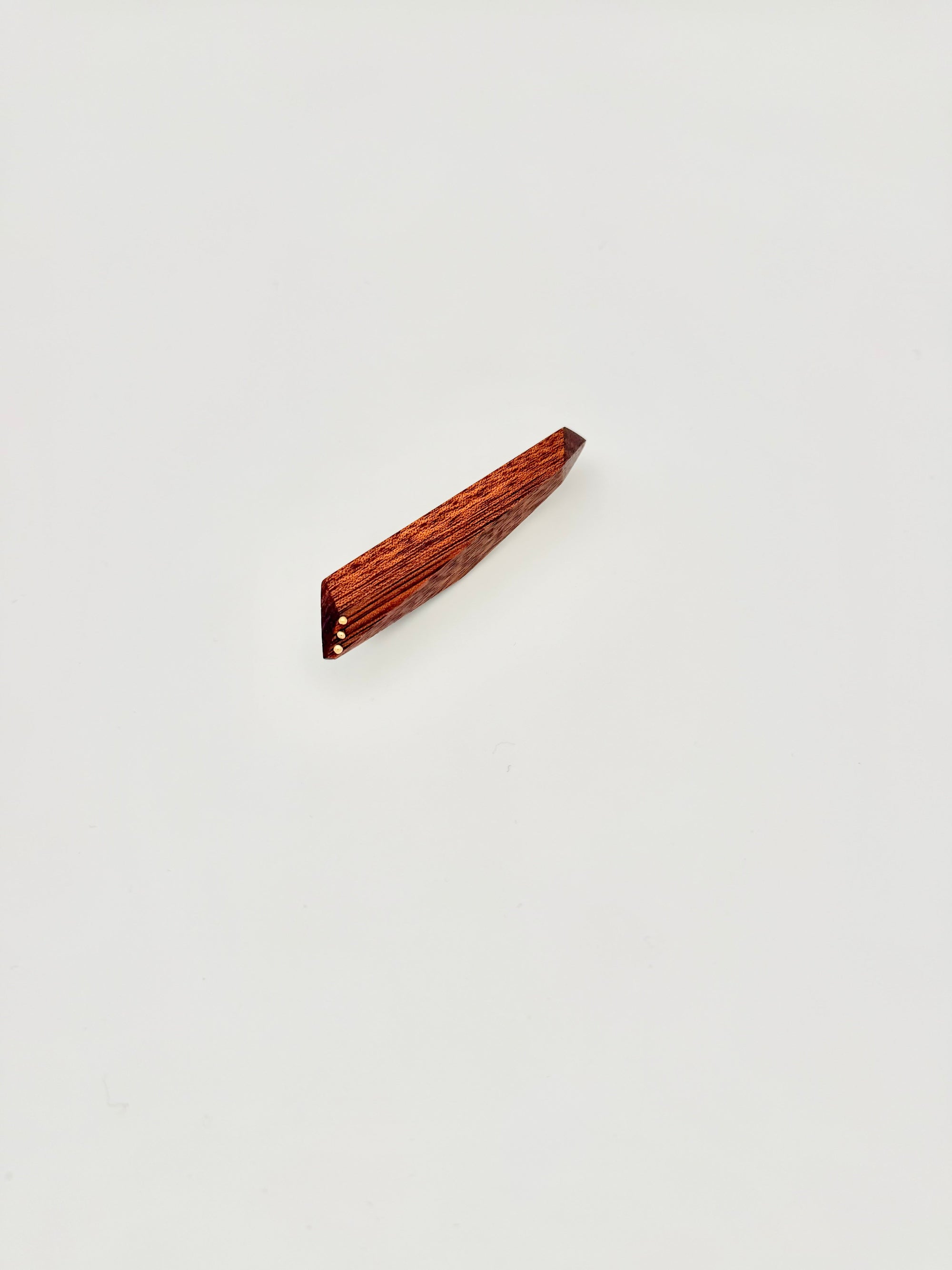 Red geometric wood brooch with 3 gold dot details on white background