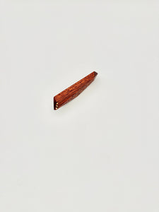 Red geometric wood brooch with 3 gold dot details on white background