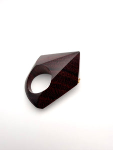Burgundy geometric wood ring on a white background