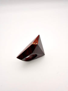 Triangular wooden object with a glossy finish on a white background
