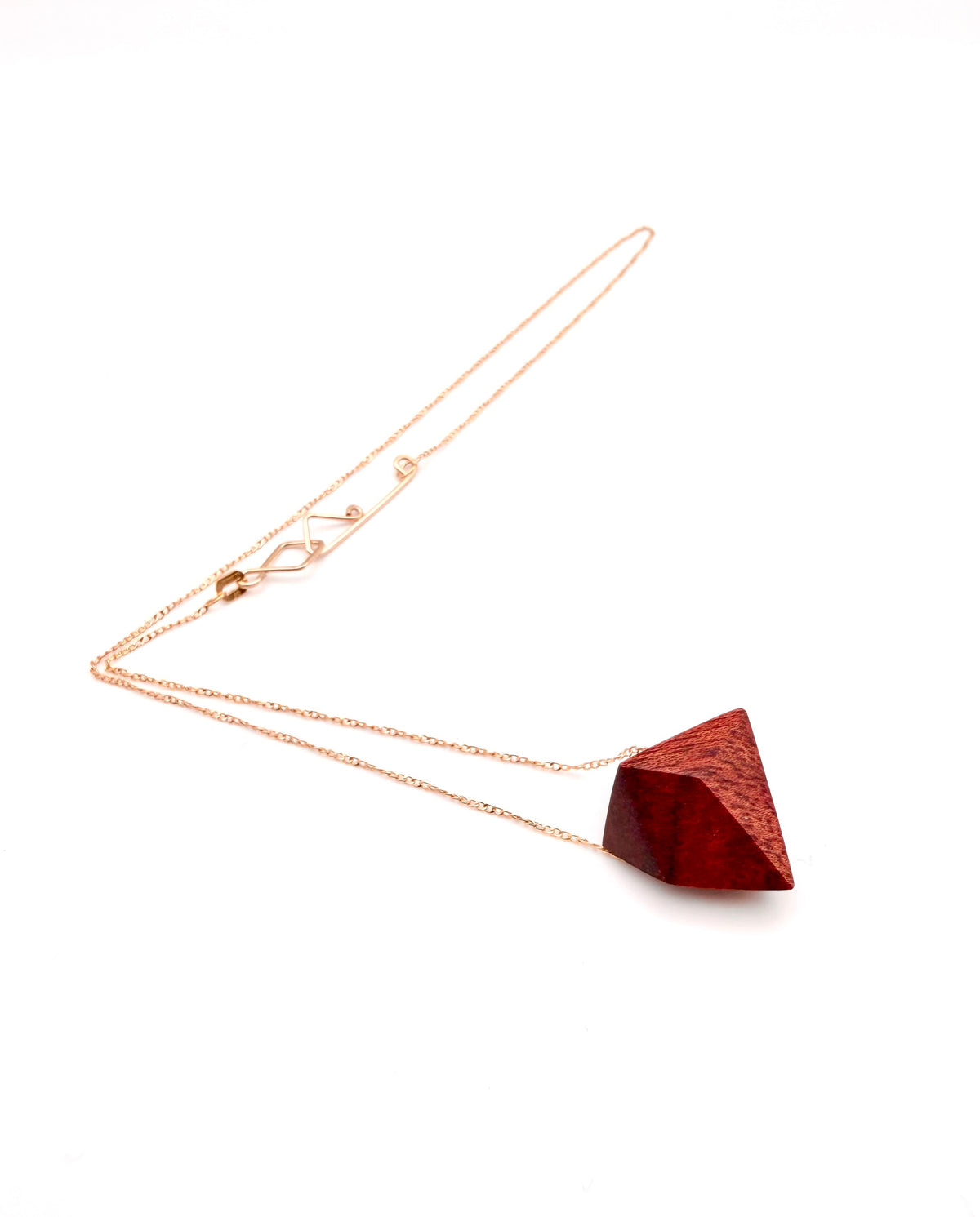 Geometric wood pendant necklace on a white background