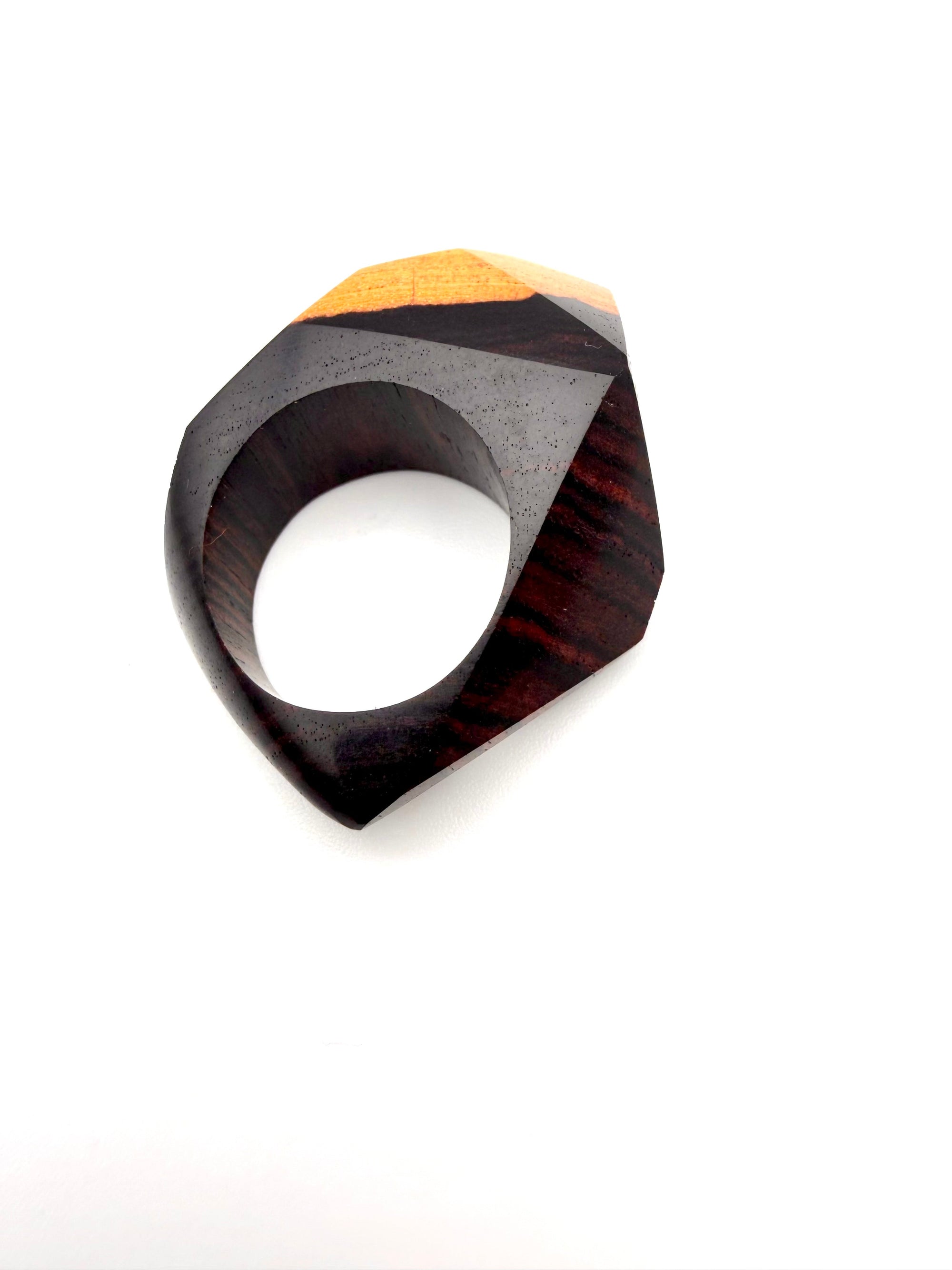 Wooden ring with a geometric design on a white background