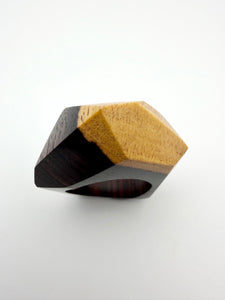 Wooden ring with a geometric design on a white background