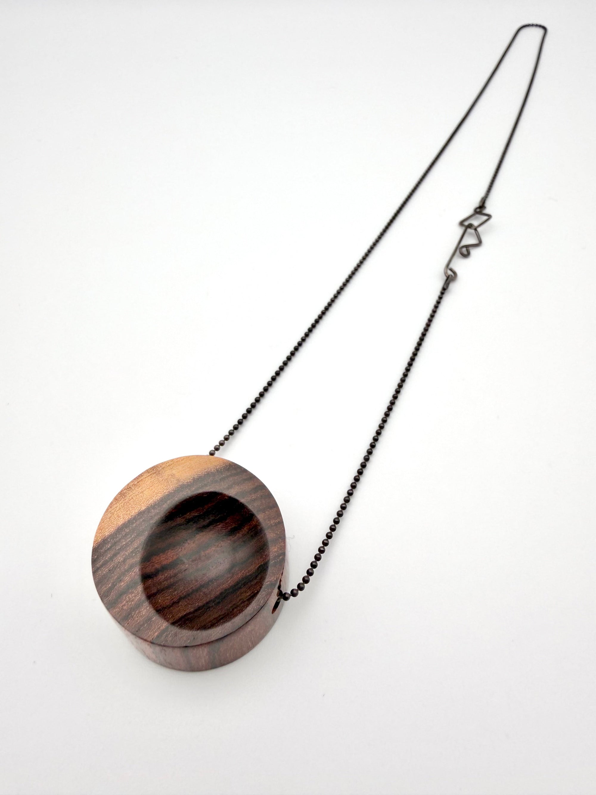 Wooden pendant with chain on a white background