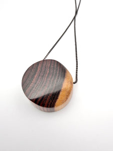 Wooden pendant necklace on a white background