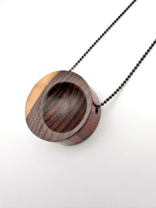 Wooden pendant necklace on a white background