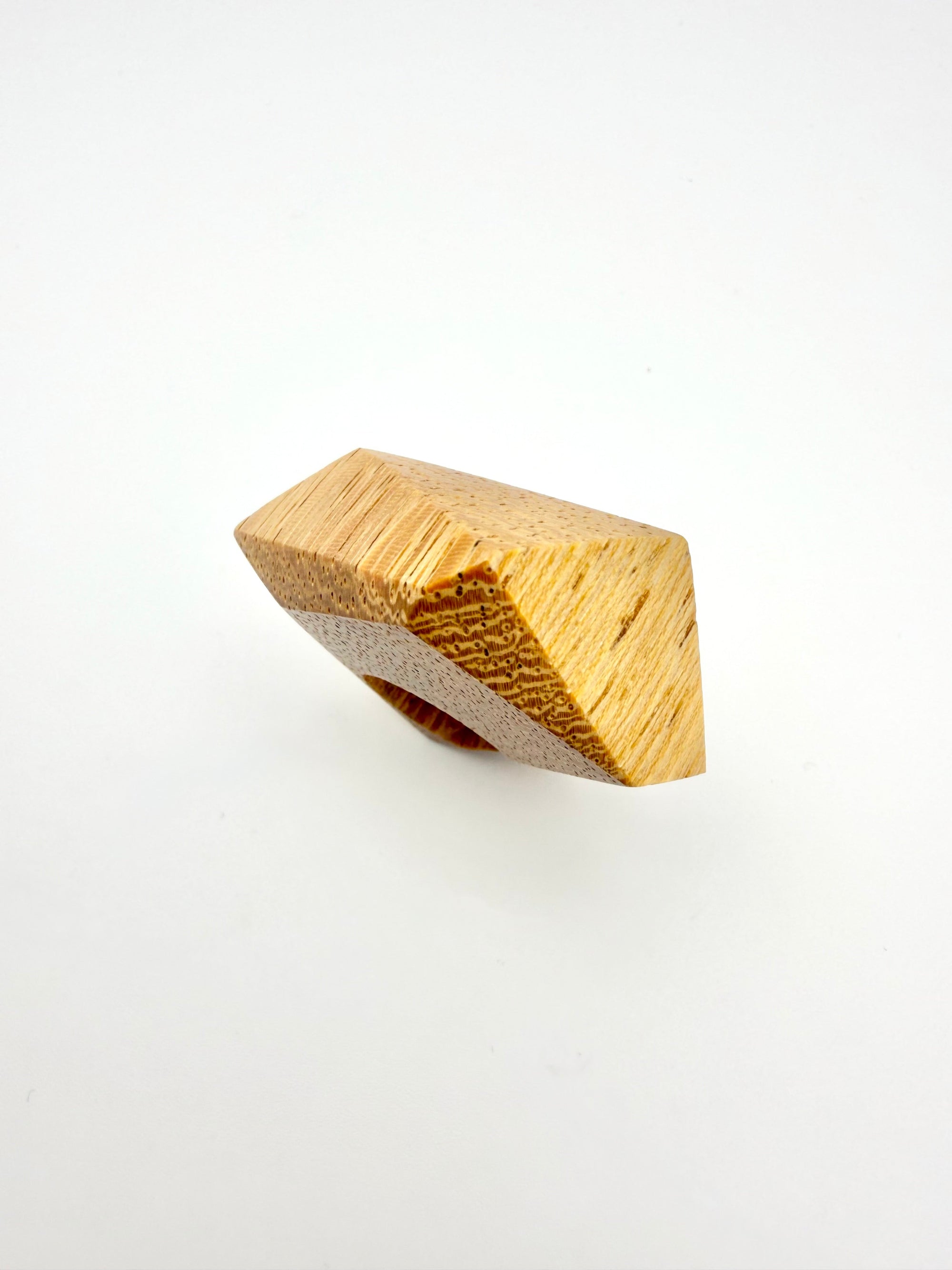 Wooden geometric ring on a white background