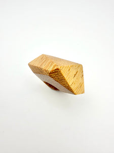 Wooden geometric ring on a white background