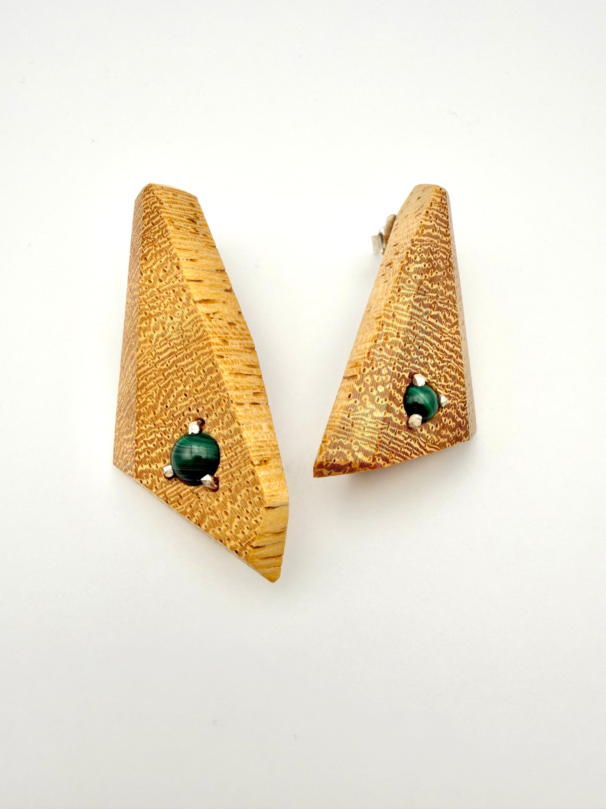 Blonde wood triangle-shaped earrings with Malachite gemstones set with silver on a white background