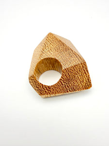Wooden ring with a geometric design on a white background