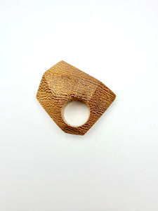 Gold tone geometric wood ring on a white background