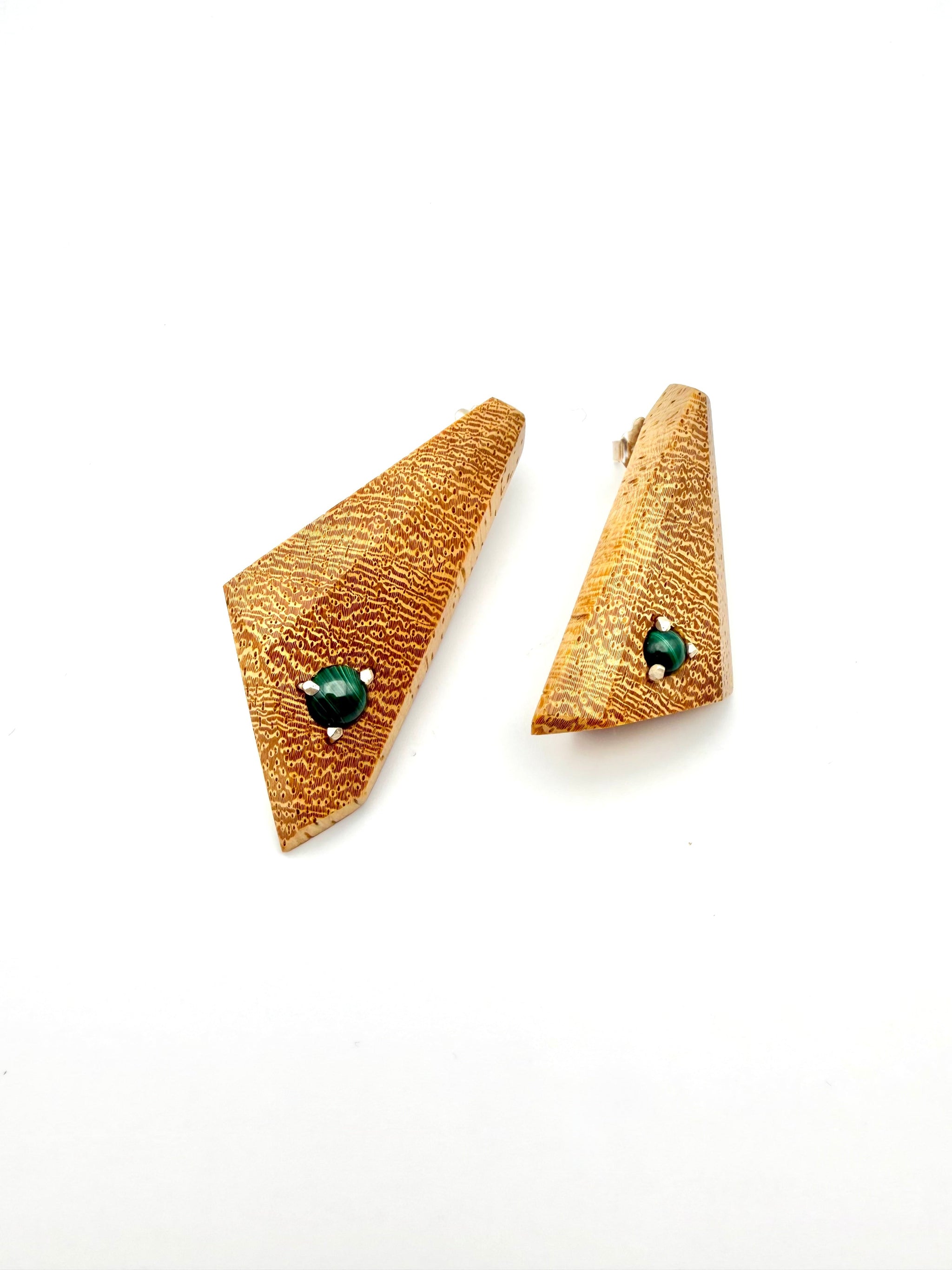 Blonde wood triangle-shaped earrings with Malachite gemstones set with silver on a white background