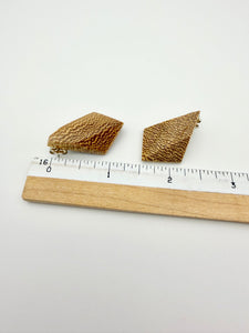 Blonde wood earrings with dramatic end grain next to ruler for scale, showing about 1" long. 