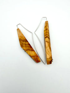 Wooden earrings with geometric design on a white background