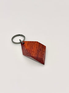 Wooden keychain with geometric design on a white background