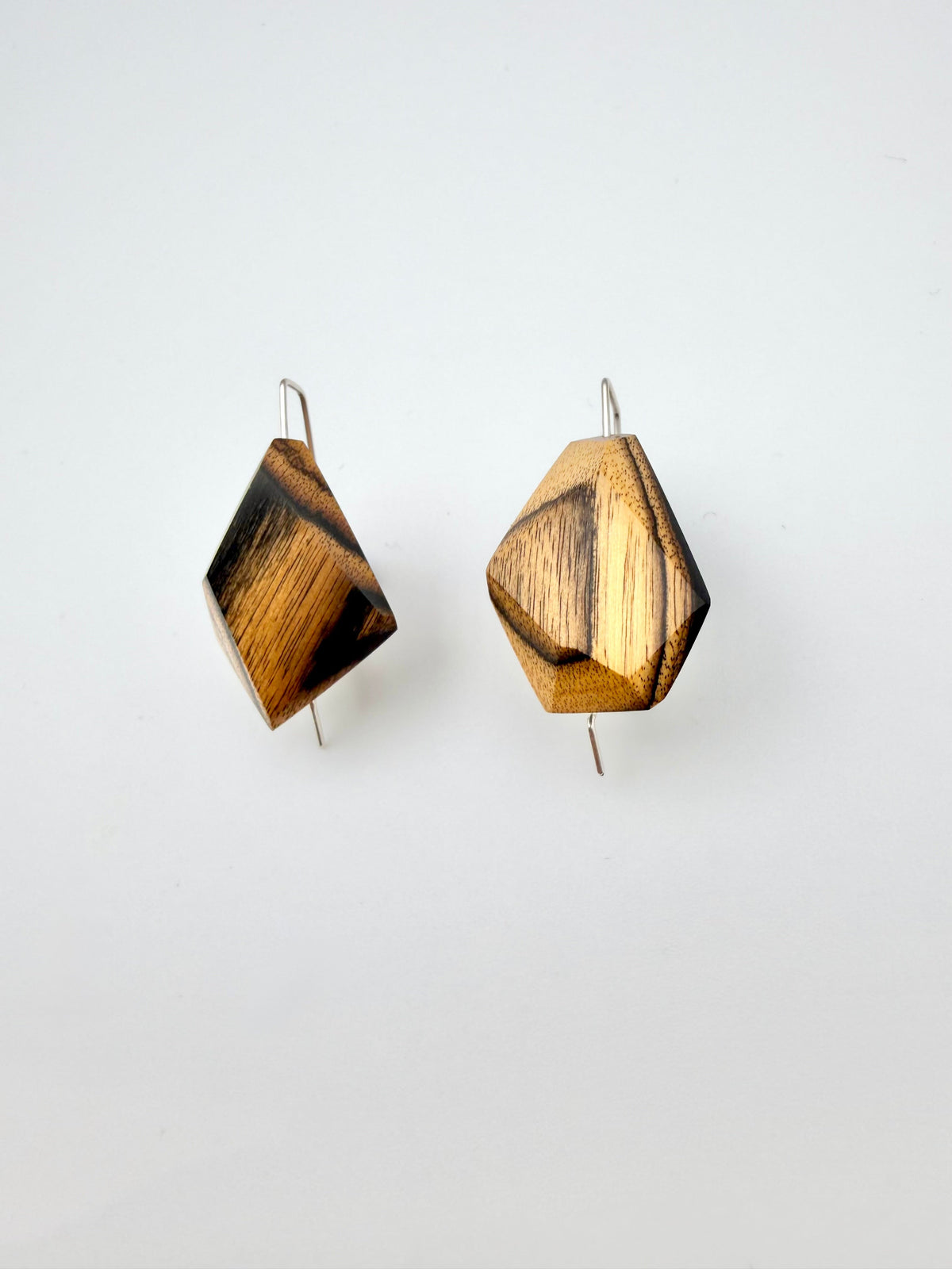 Black & Blonde geometric earrings on a white background