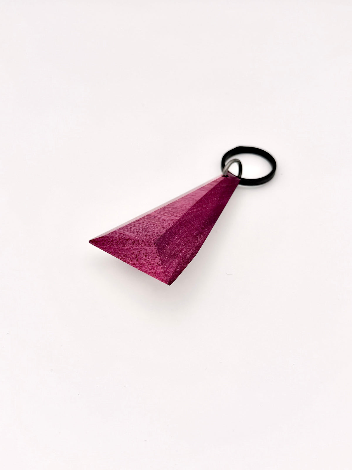 Purple triangular wood keychain on a white background