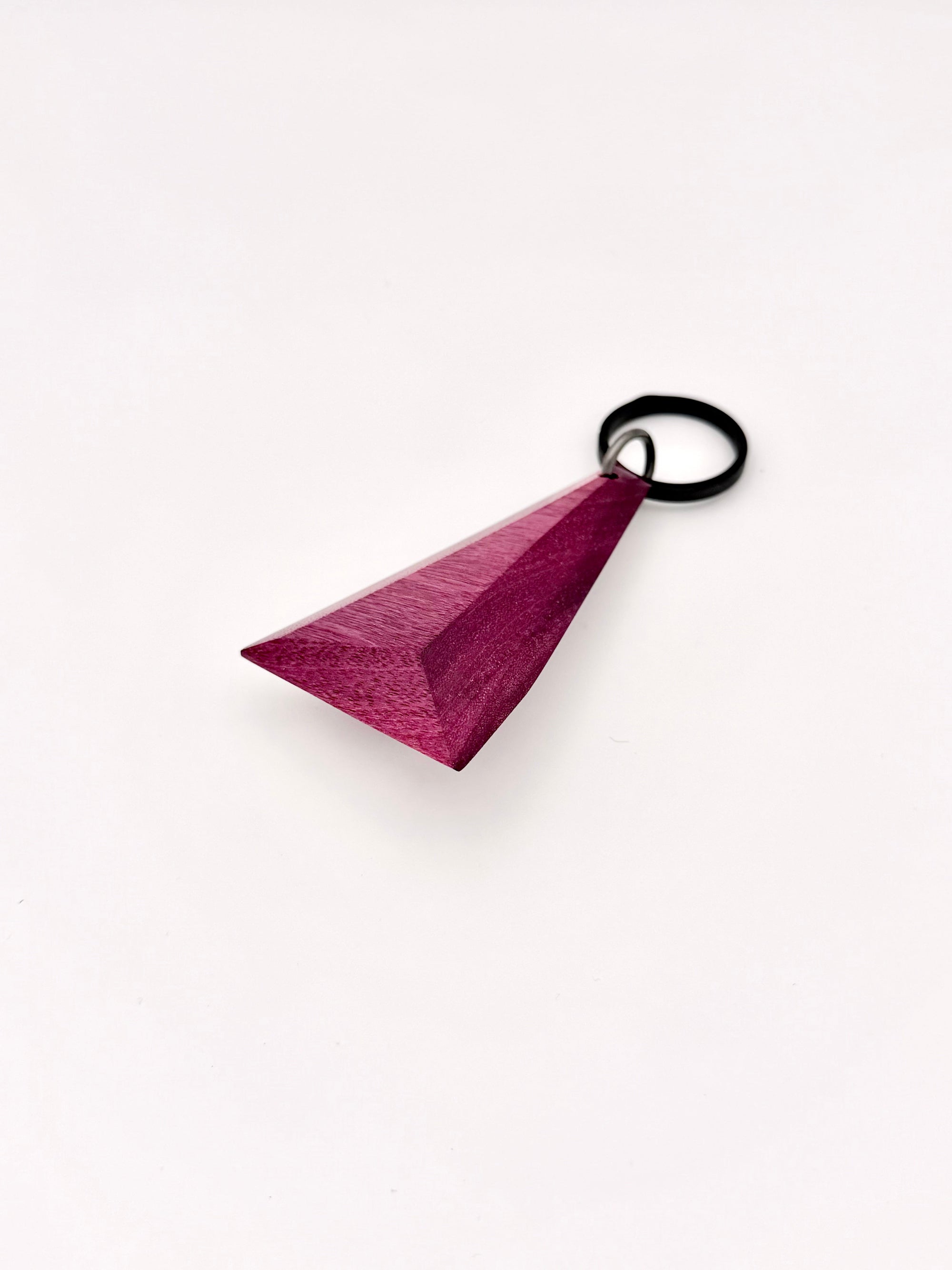 Purple triangular wood keychain on a white background