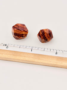 wood geometric earrings next to ruler for scale. 