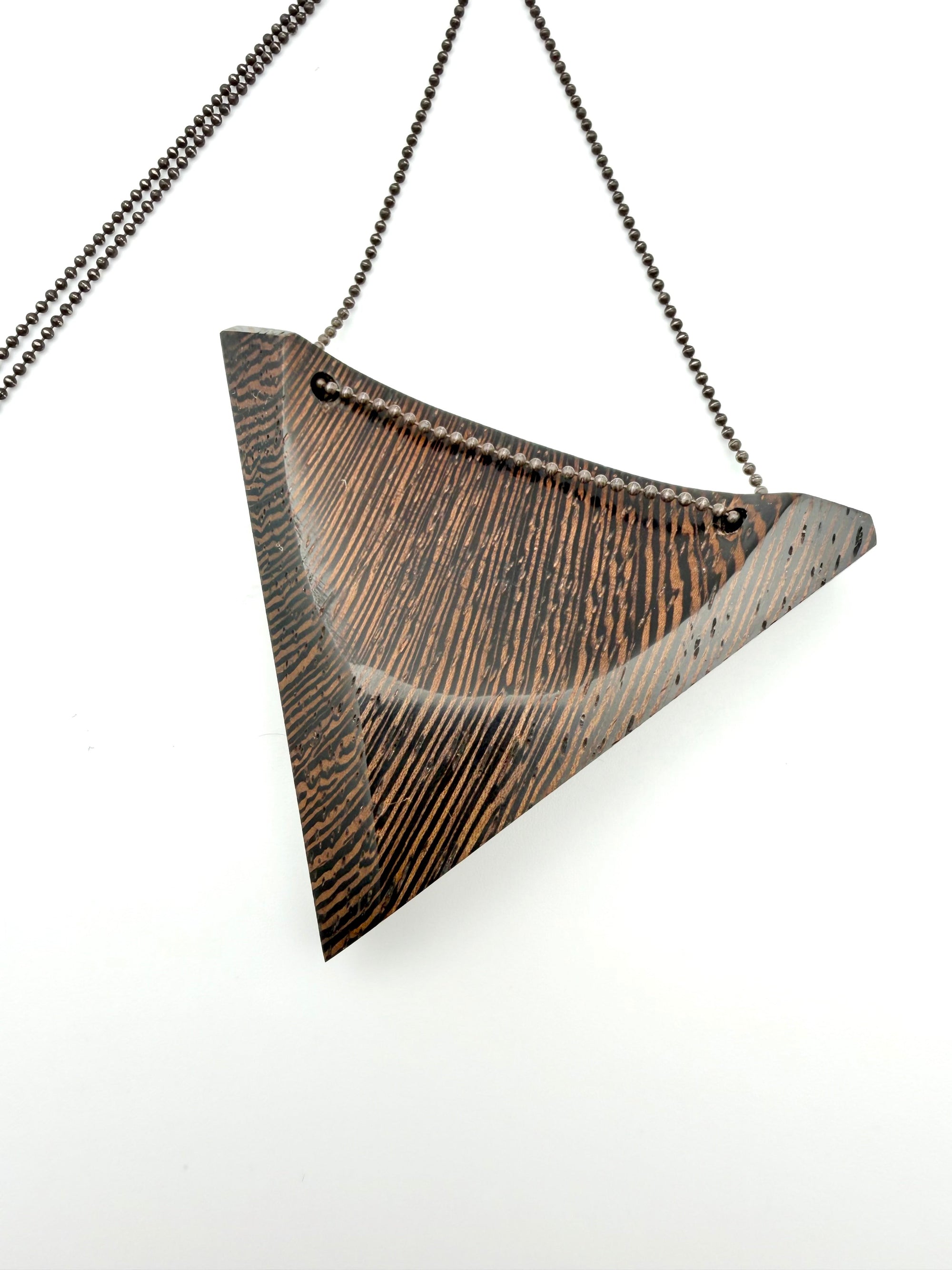 Triangular Wood Pendant on Black Chain with custom clasp on white background. 