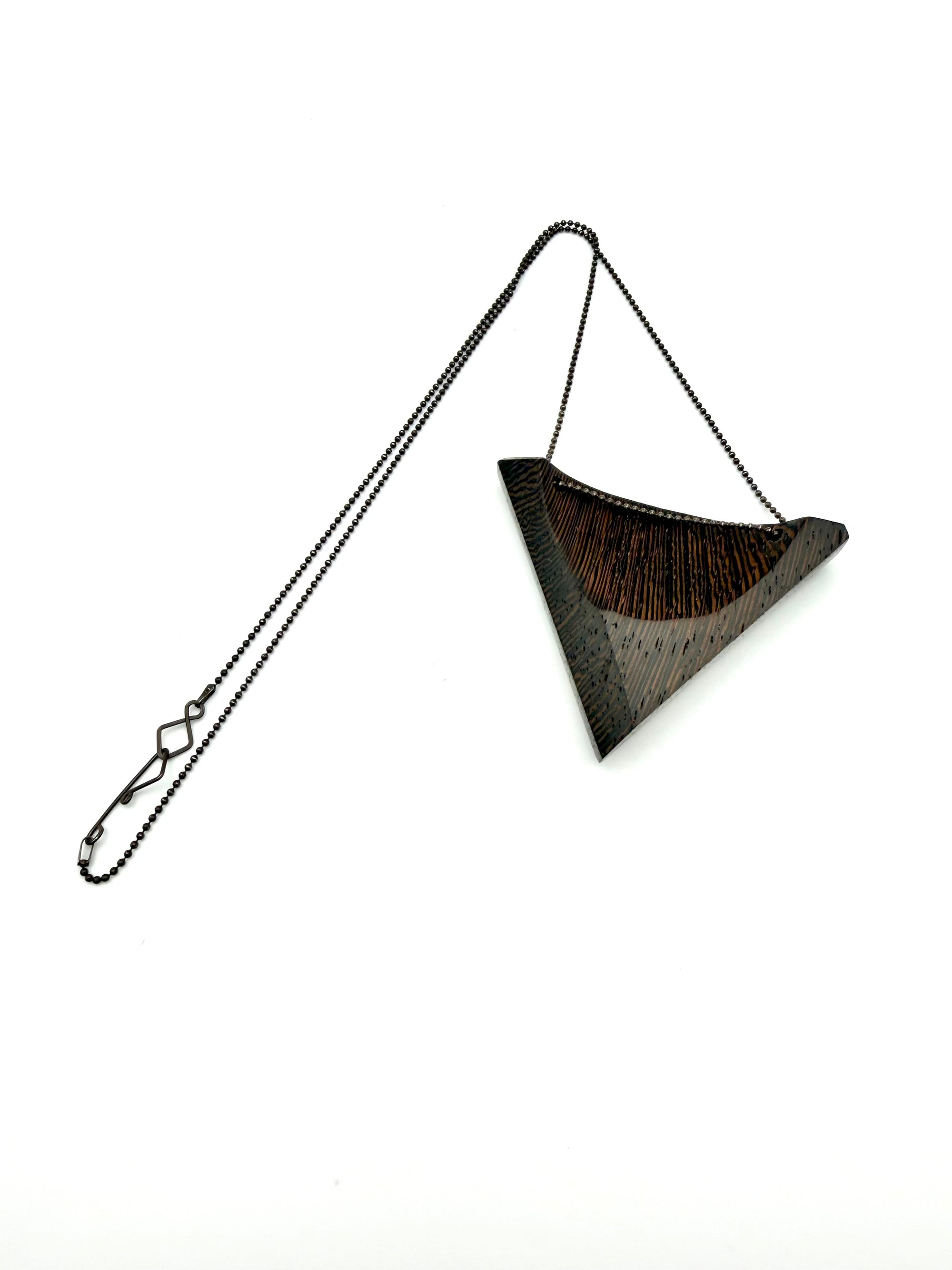 Triangular Wood Pendant on Black Chain with custom clasp on white background. 