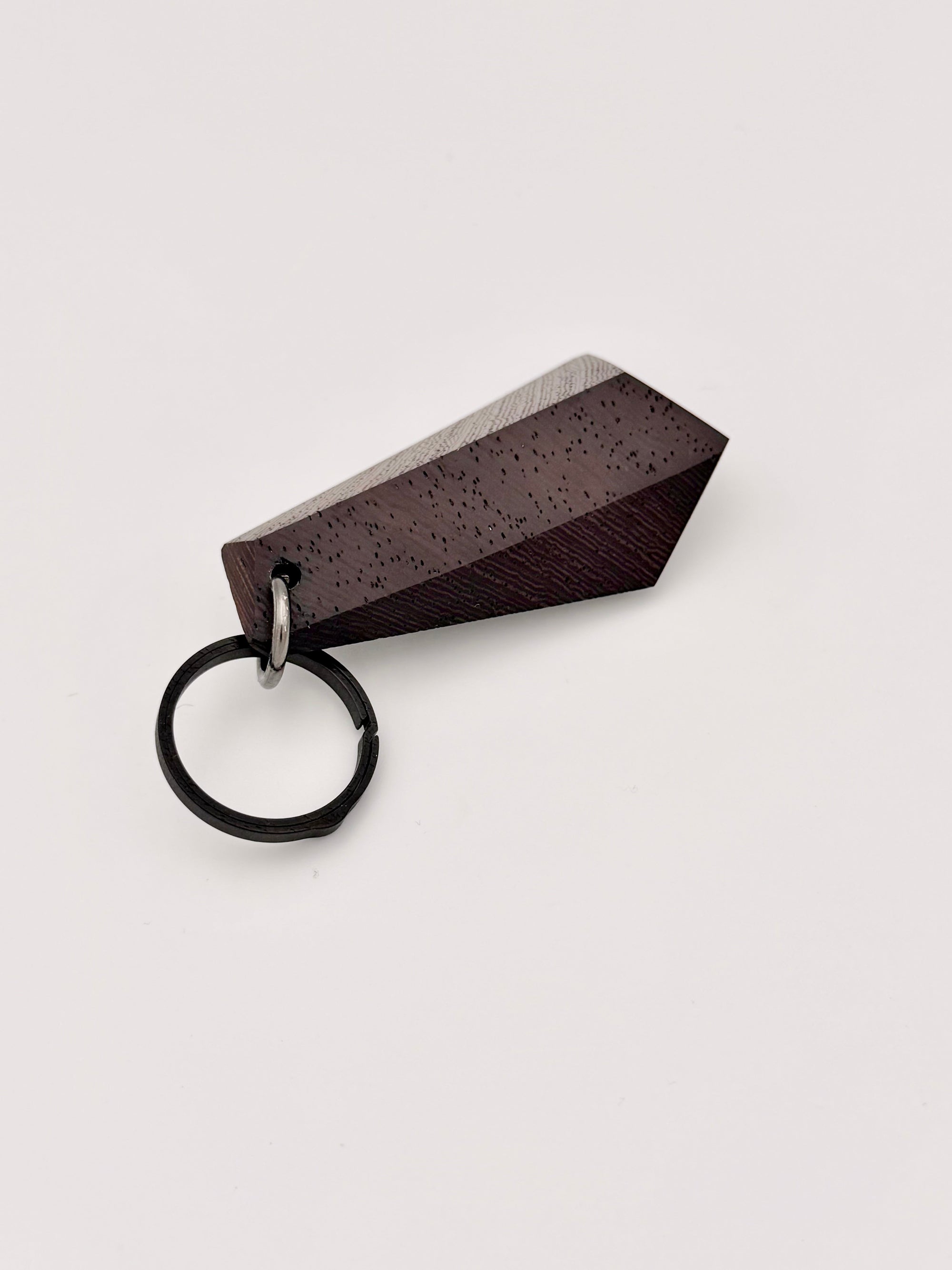 Wood keychain with geometric design on a light gray background