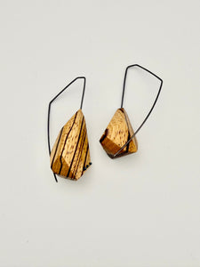 Asymmetrical zebrawood earrings with oxidized angular hoops and oxidized dot details. 