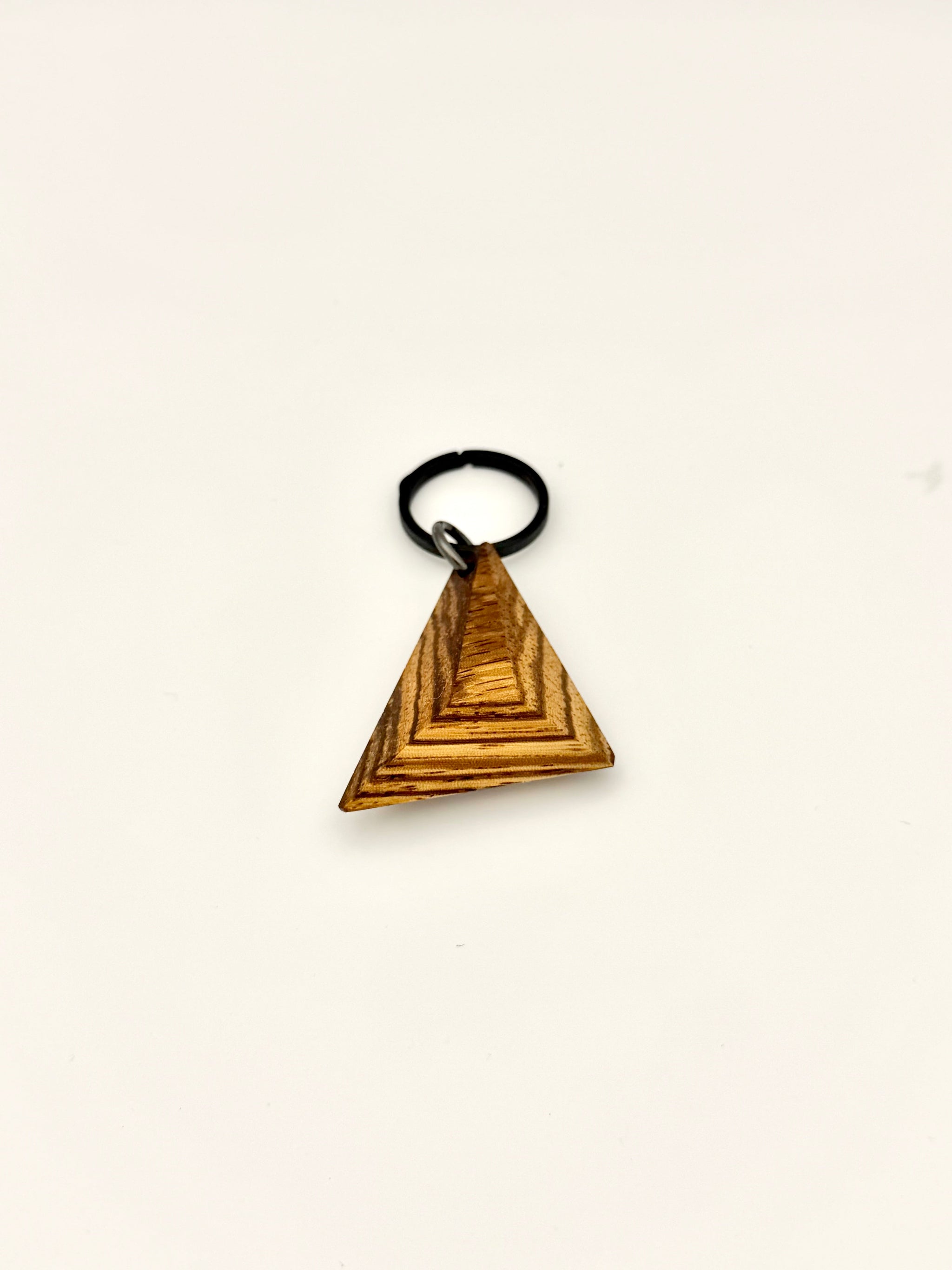 Striped wood keychain with black titanium ring. 