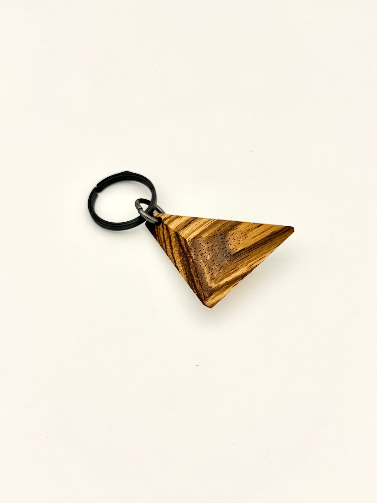 Striped wood keychain with black titanium ring. 