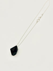 Necklace with a black pendant on a white background